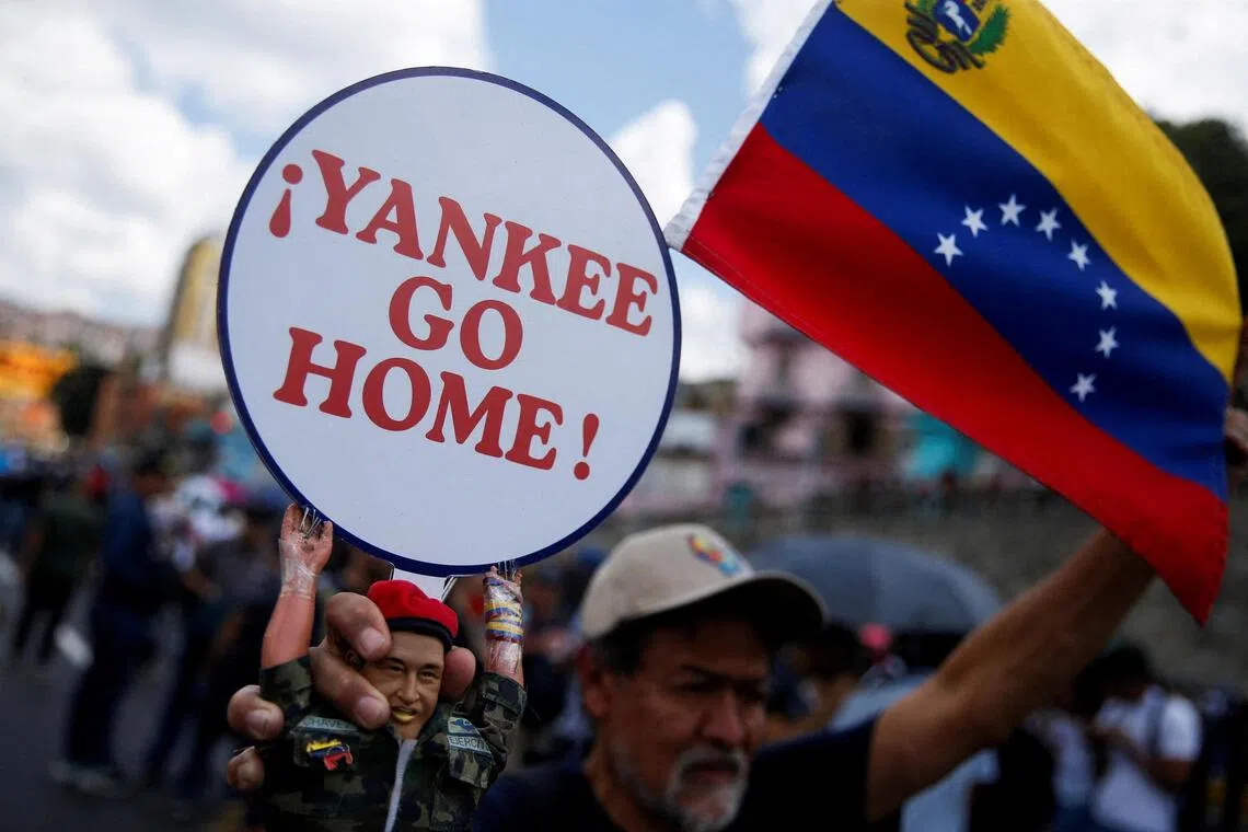 A protester with a toy depicting the late Venezuelan president Hugo Chavez during a rally in Caracas on Oct 6 in support of President Nicolas Maduro, amid rising tensions with the US. 