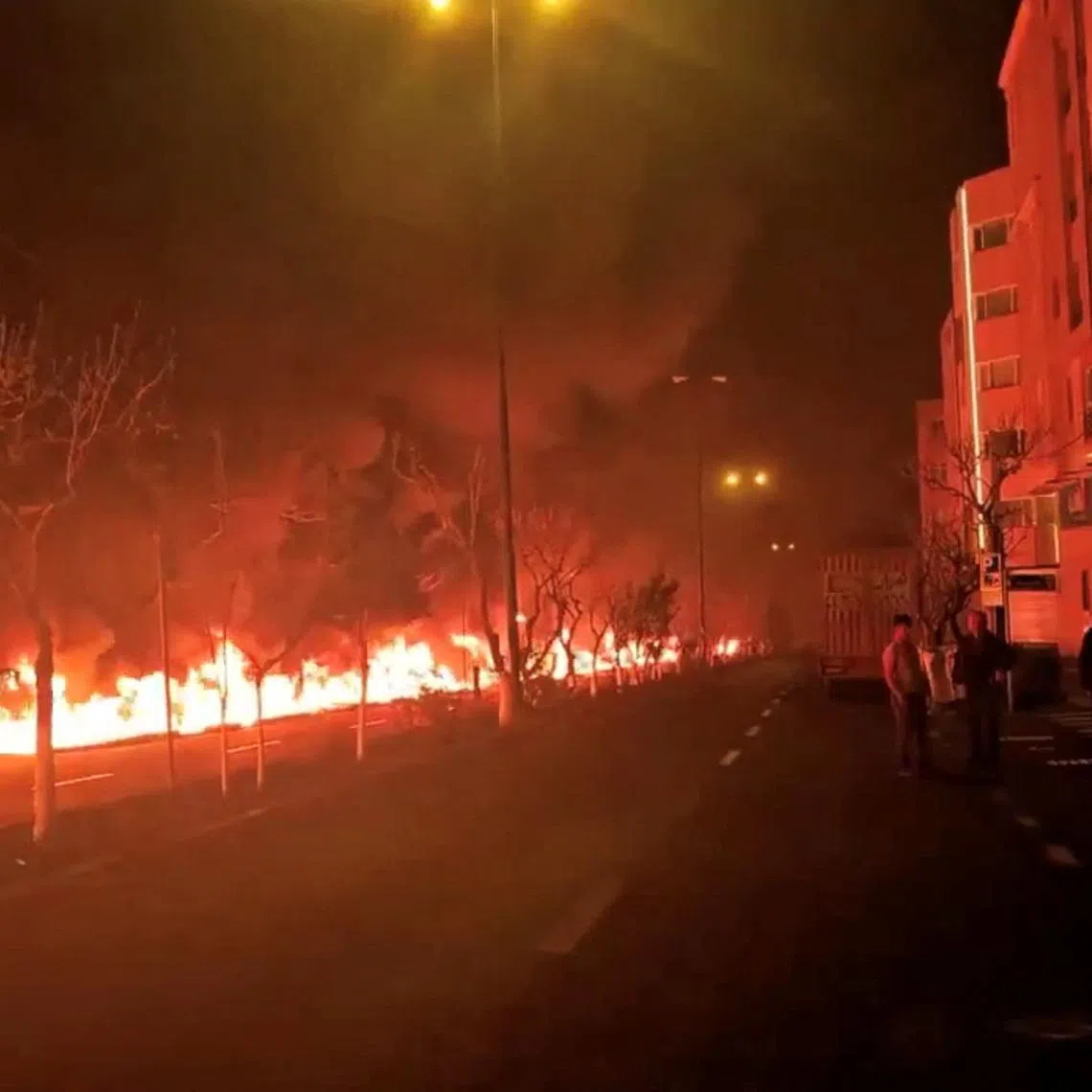 Fire burns along Tehran's Koohsar Boulevard in this screengrab from a video on social media released on March 8. Israeli strikes on Tehran oil infrastructure in March produced toxic fumes.