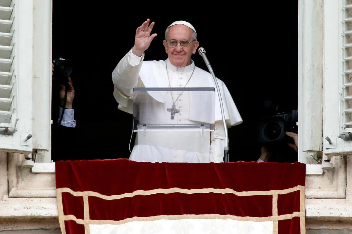FILE PHOTO: Newly elected Pope Francis appears at the window of his future private apartment to bless the faithful, gathered below in St. Peter's Square, during the Sunday Angelus prayer at the Vatican March 17, 2013. REUTERS/Tony Gentile/File Photo