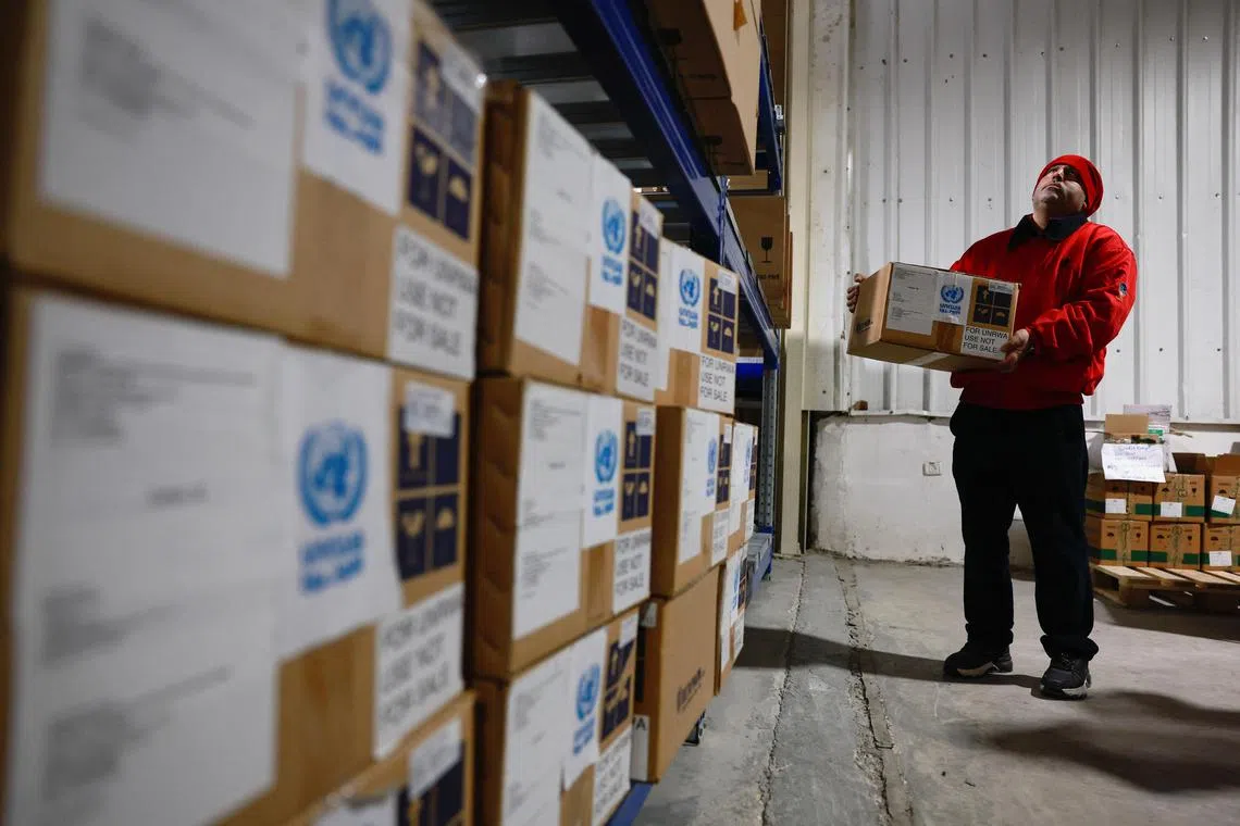 An UNRWA worker moves a box of humanitarian aid at a warehouse in East Jerusalem.