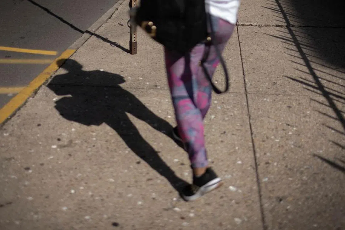 An Ecuadorean asylum seeker who said she was kidnapped and sexually trafficked near the U.S.-Mexico border walks down a street in New Jersey, U.S., on August 18, 2023. REUTERS/Maye-E Wong