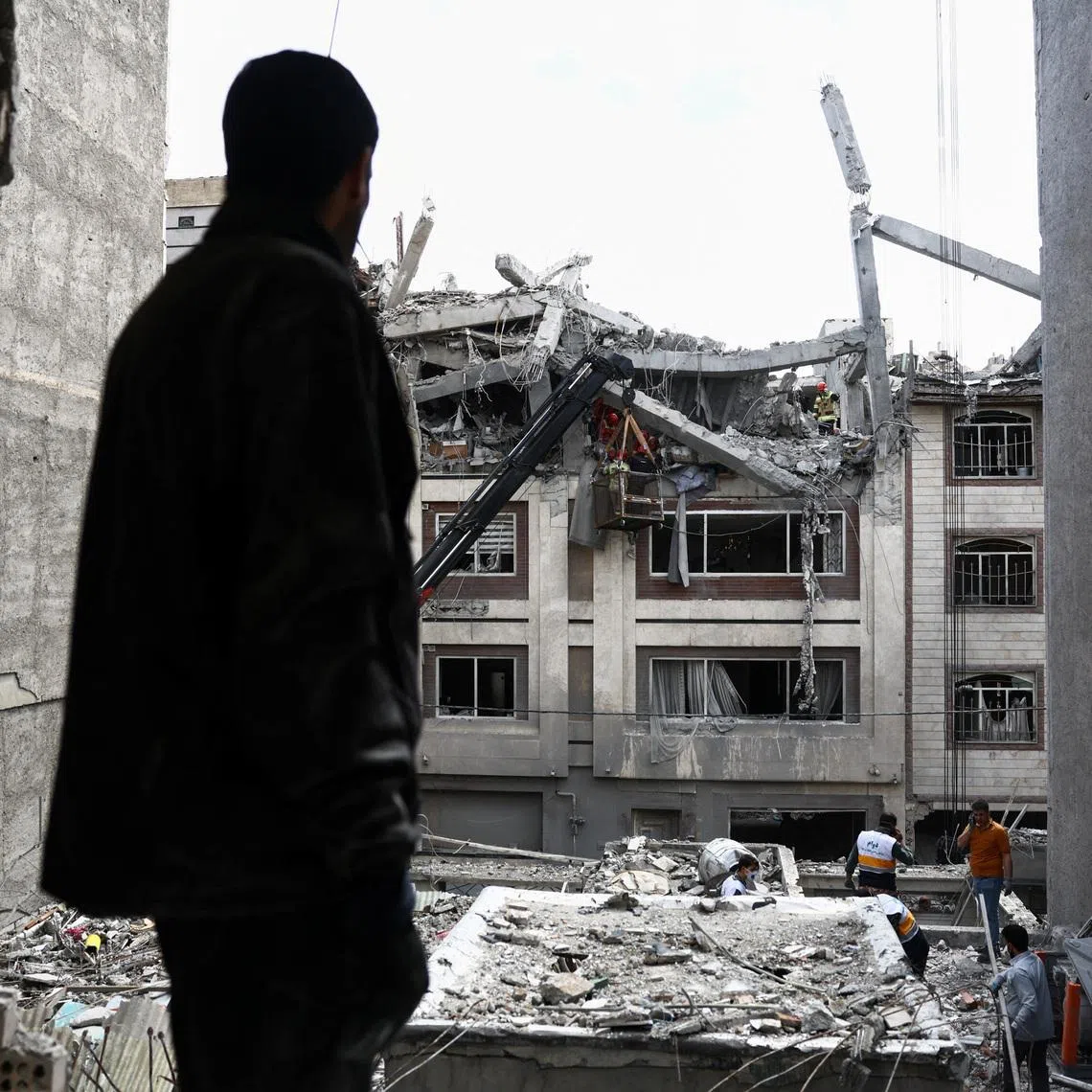 A man looks at a residential building damaged by a strike, amid the U.S.-Israeli conflict with Iran, in Tehran, Iran, March 27, 2026. Majid Asgaripour/WANA (West Asia News Agency) via REUTERS