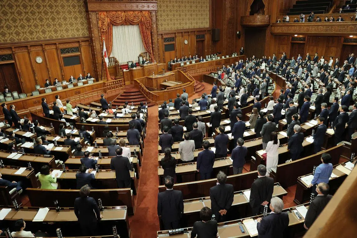 Members of the chamber vote to pass the revised Immigration Control and Refugee Recognition Act, which reviews the detention and deportation rules of foreigners, during a plenary session of the House of Councillors at the Parliament building in Tokyo on June 9, 2023. 