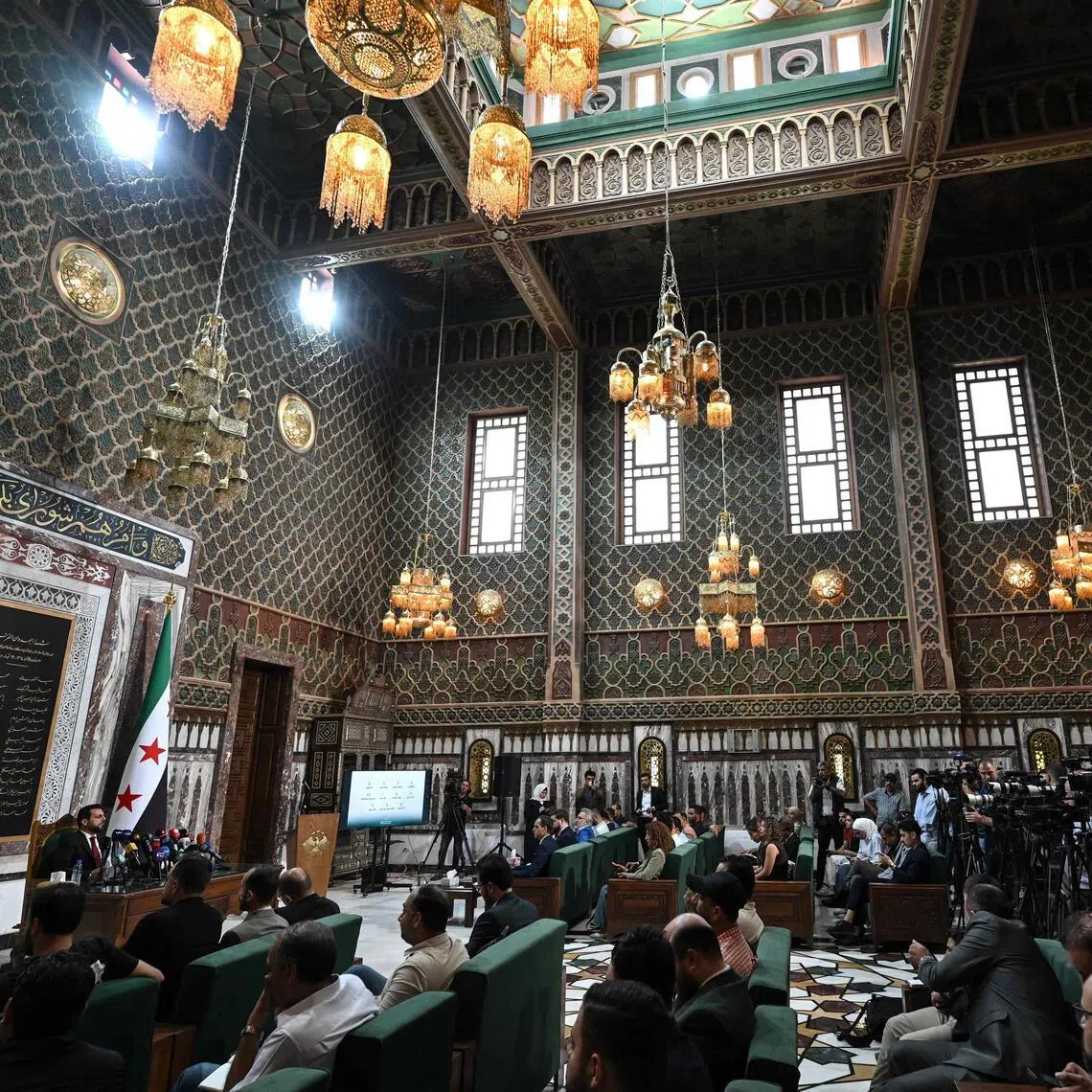 Mohammad Taha al-Ahmad (left), head of the higher electoral committee, read out the names of the 70 members appointed by presidential decree.