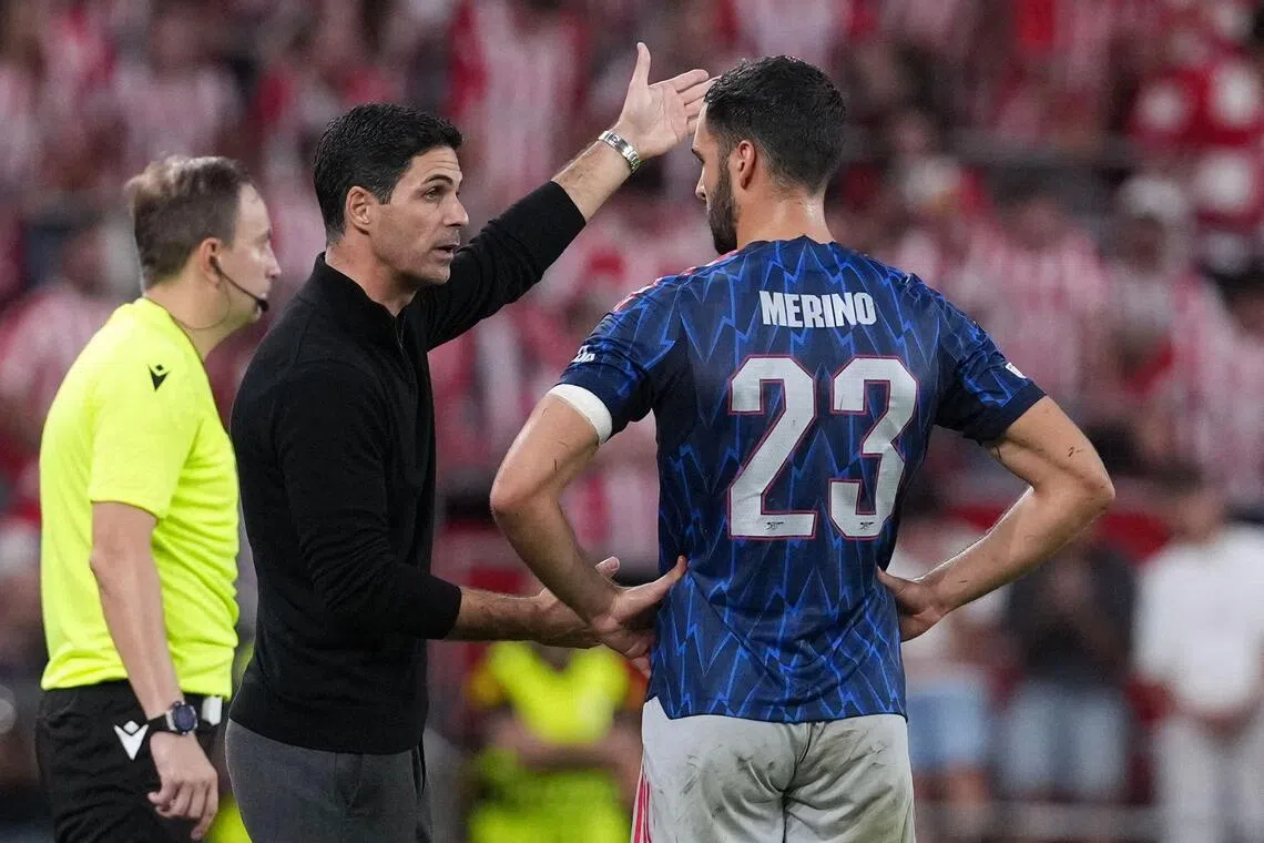 Arsenal manager Mikel Arteta speaks to Mikel Merino during their Champions League clash against Athletic Bilbao.