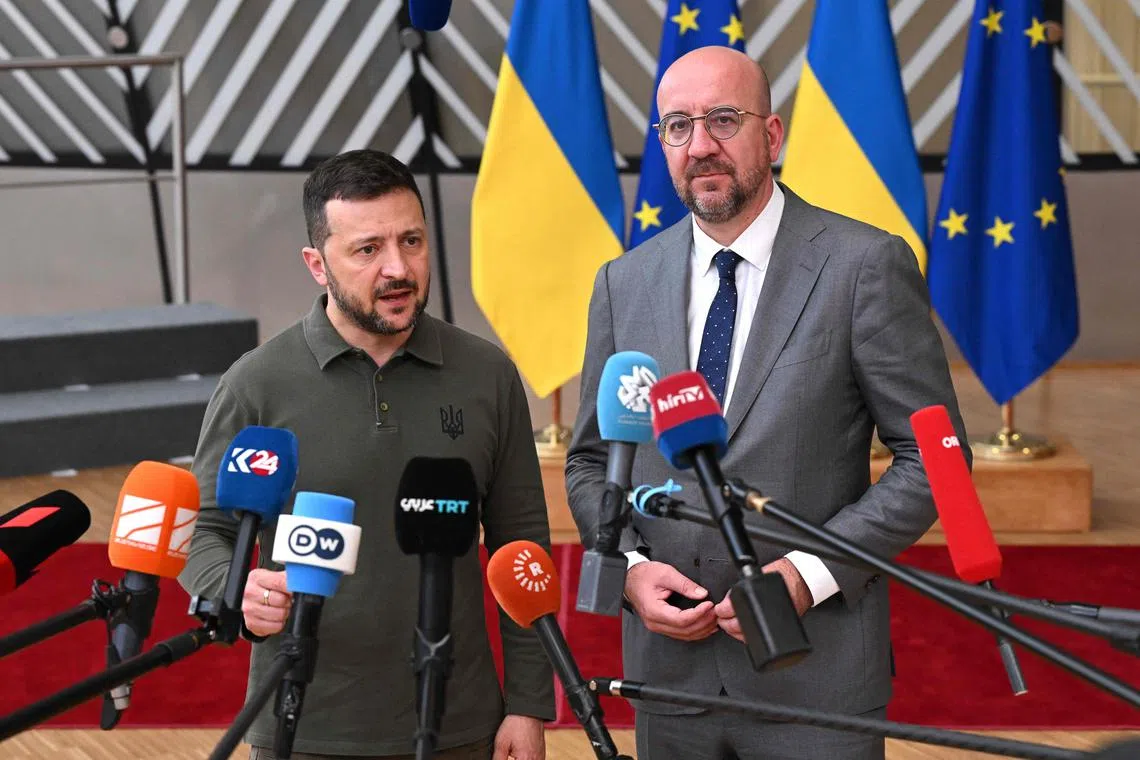 Ukrainian President Volodymyr Zelensky (left) answering journalists' questions next to European Council president Charles Michel, in Brussels
 on June 27.