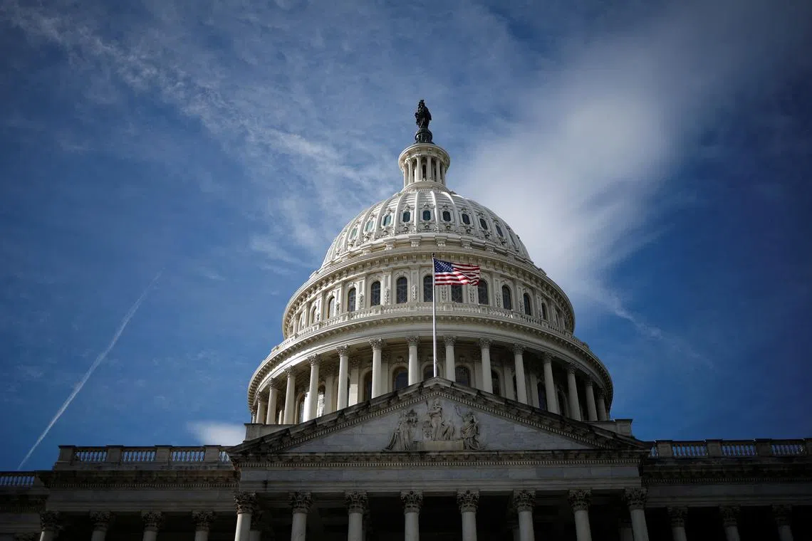 FILE PHOTO: A U.S. flag is mounted on the U.S. Capitol in Washington, U.S., December 8, 2024. REUTERS/Benoit Tessier/File Photo