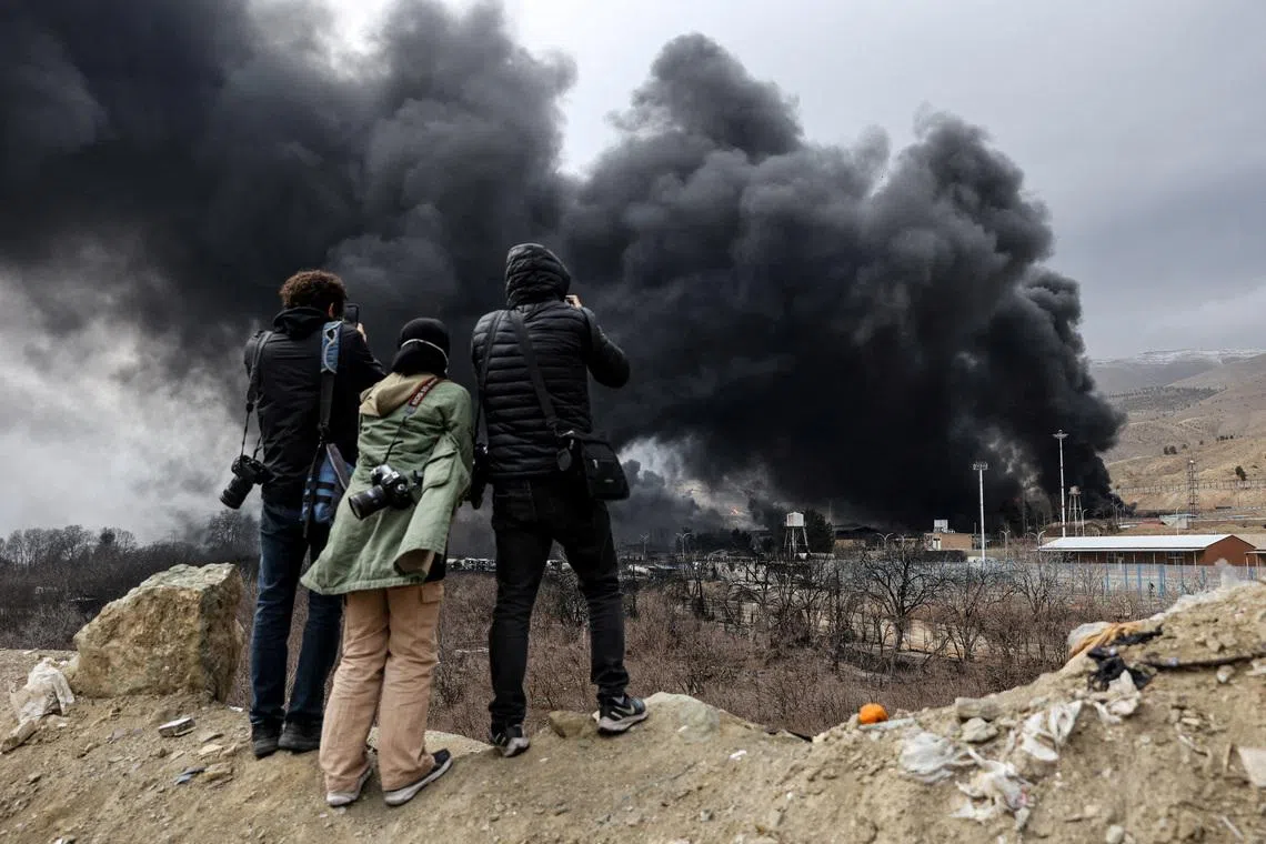 People record smoke rising after a reported strike on Shahran fuel tanks, amid the U.S.-Israeli conflict with Iran, in Tehran, Iran, March 8, 2026. Majid Asgaripour/WANA (West Asia News Agency) via REUTERS