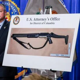 US Attorney for the District of Columbia Jeanine Pirro points at a picture of a shotgun carried by Cole Tomas Allen, the suspect in the shooting incident, with acting Attorney-General Todd Blanche, FBI Director Kash Patel next to her at a press conference at the US Department of Justice, in Washington.