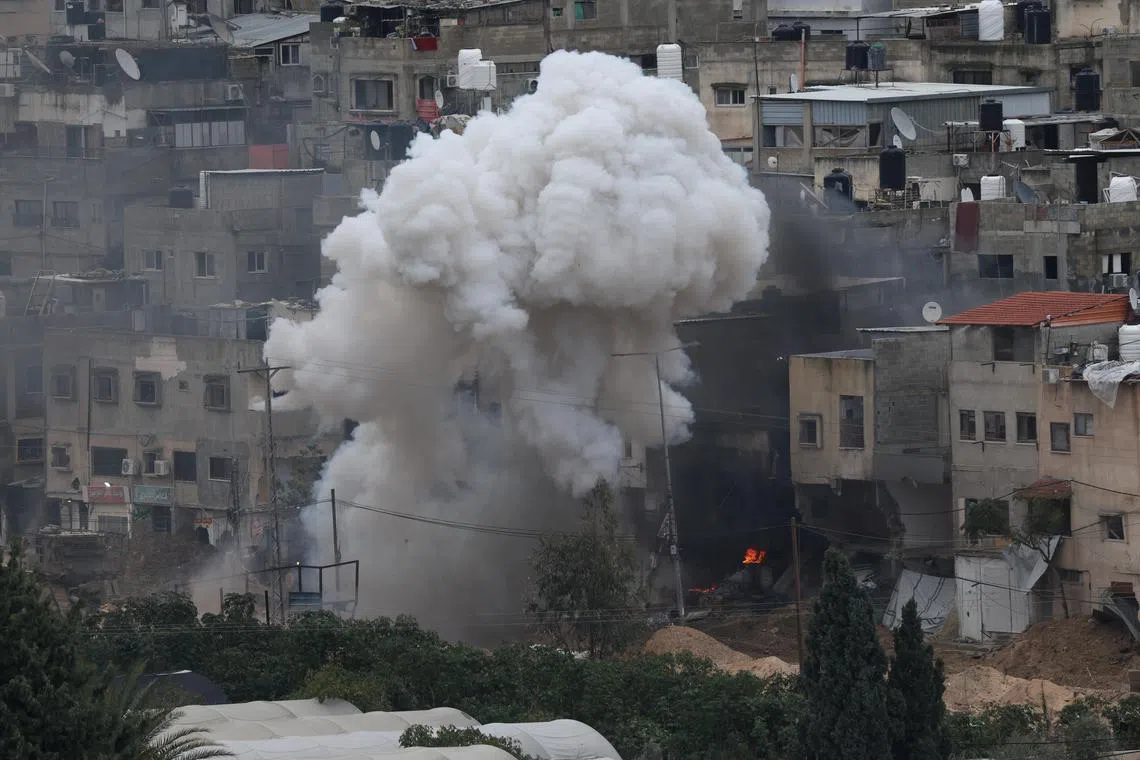 Smoke billows above the Nur Shams refugee camp during an Israeli military operation near the West Bank city of Tulkarem on Feb 9, 2025.