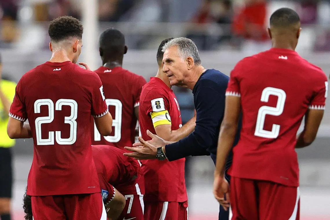 Carlos Queiroz gives instructions to Moustafa Tarek and teammates during Qatar's World Cup qualifier against Afghanistan.