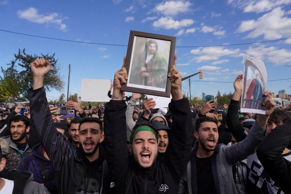 People from the Alawite sect protest as they demand federalism and an end to what they say is the killing and violations against Alawites, in Latakia, Syria, December 28, 2025. REUTERS/Karam al-Masri
