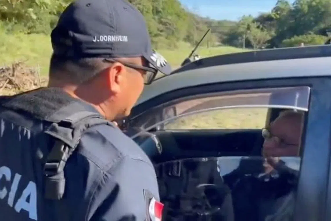 A police officer speaks to Jose Luis Lacunza, a Roman Catholic Cardinal, who has been found \"safe and sound\" after being reported missing for two days, in Boquete, Panama February 1, 2024, in this screen grab obtained from social media video. Policia Nacional de Panama @ProtegeryServir via X/via REUTERS