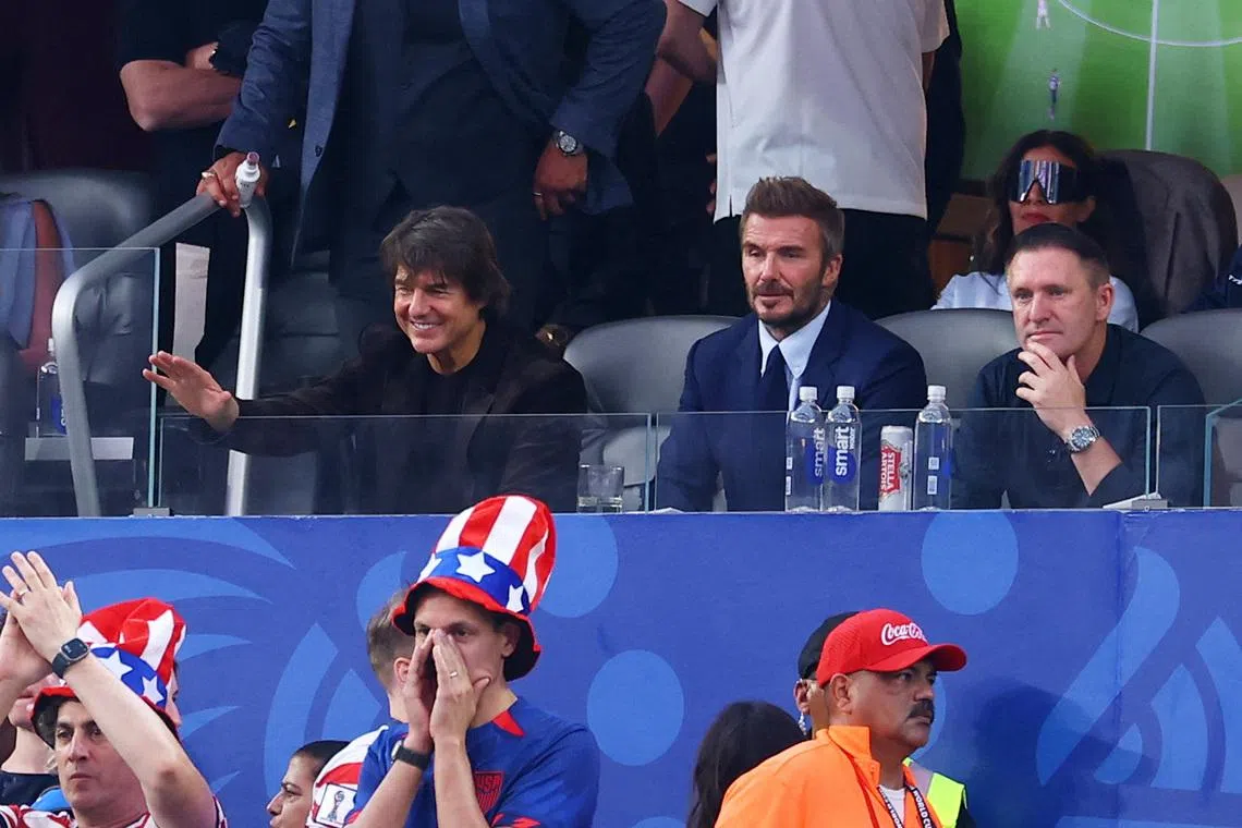 (From left) Actor Tom Cruise and former footballers David Beckham and Robbie Keane in the stands of the US vs Paraguay match on June 12.