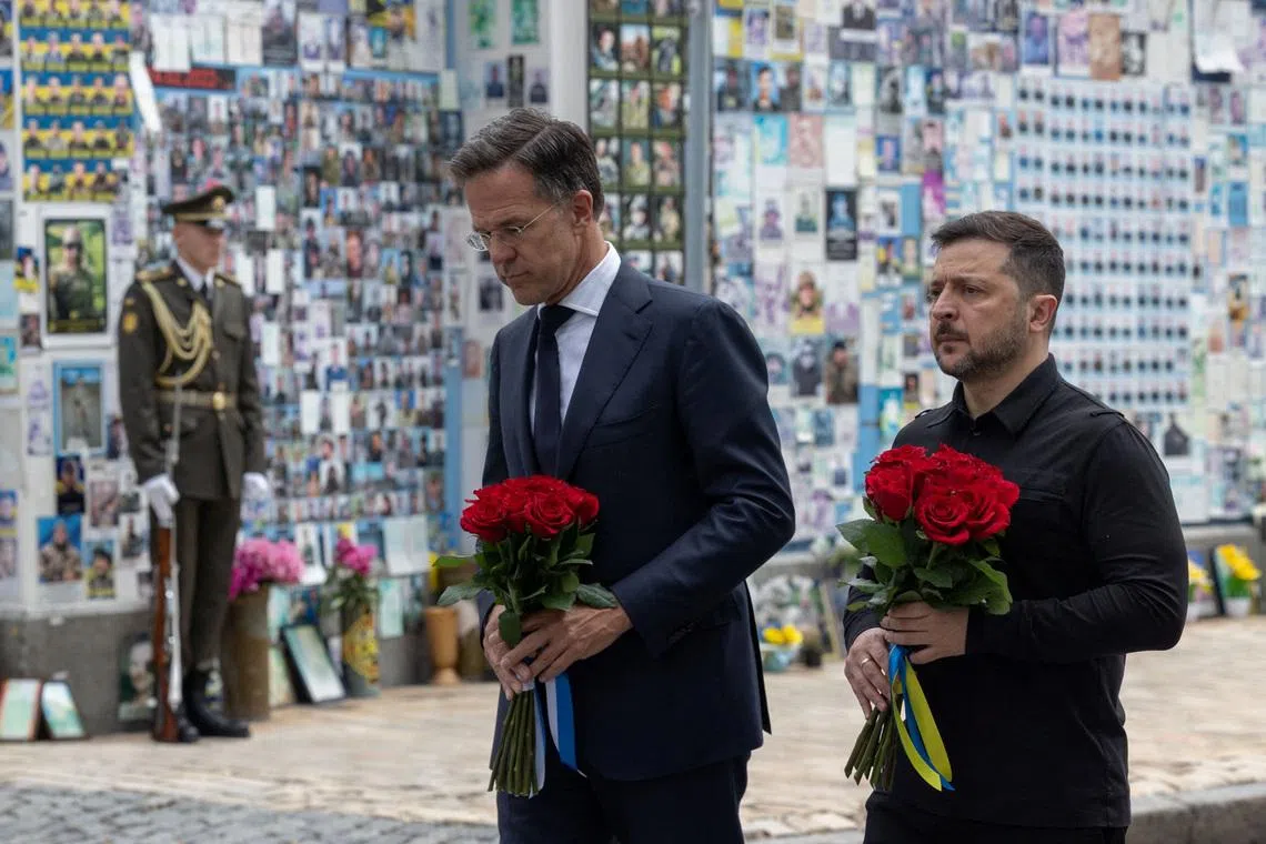 Ukraine's President Volodymyr Zelensky and NATO Secretary-General Mark Rutte visit the Wall of Remembrance of the Fallen Defenders of Ukraine on June 3 outside the St Michael's Cathedral in Kyiv, Ukraine.