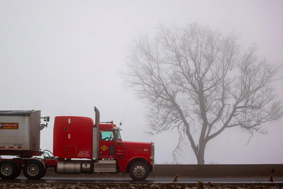 A transport truck travels along Highway 401, a vital trade corridor linking Canada to U.S. markets, Ingersoll, Ontario, Canada, February 3, 2025. REUTERS/Carlos Osorio