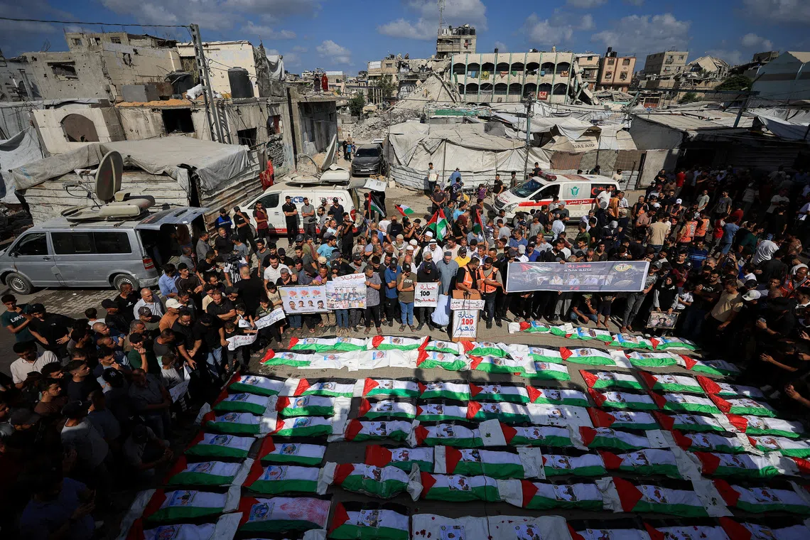 FILE PHOTO: Palestinians attend the mass funeral for members of the Irahem, Malaka, Qanbour, Balawi and Dahdouh families, who were killed in an Israeli strike in 2023 and whose remains were recovered from beneath the rubble, according to Gaza’s Civil Defense, in Gaza City, September 6, 2026. REUTERS/Dawoud Abu Alkas/File Photo