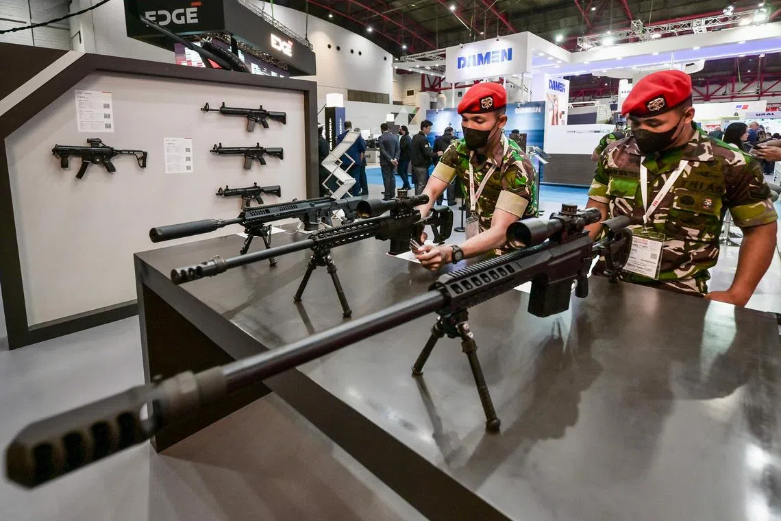 Military officers examining sniper rifles at the Indo Defence Expo in Jakarta on Nov 2, 2022.