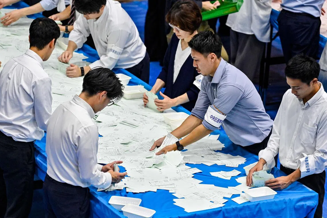 Election officials preparing to count votes for Japan's general election in Tokyo on Oct 27.