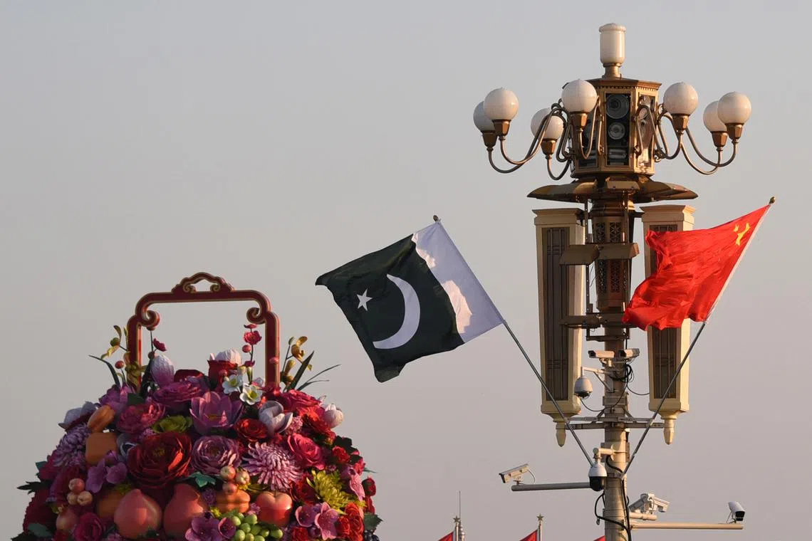Pakistani and Chinese national flags flutter next to an installation featuring a giant flower basket at the Tiananmen Square in Beijing, China October 7, 2019. Picture taken October 7, 2019. REUTERS/Stringer ATTENTION EDITORS - THIS IMAGE WAS PROVIDED BY A THIRD PARTY. CHINA OUT.