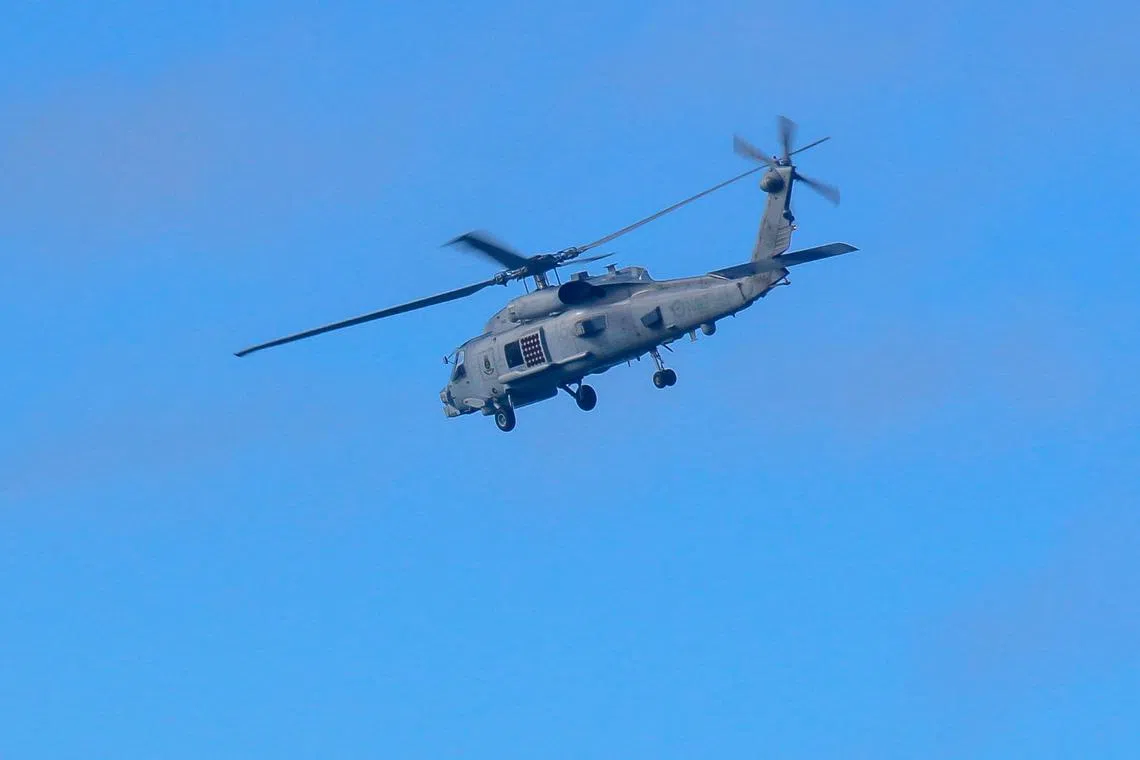 A Royal Australian Navy helicopter conducting search and rescue operations in the vicinity of Lindeman Island, Queensland, on July 29.