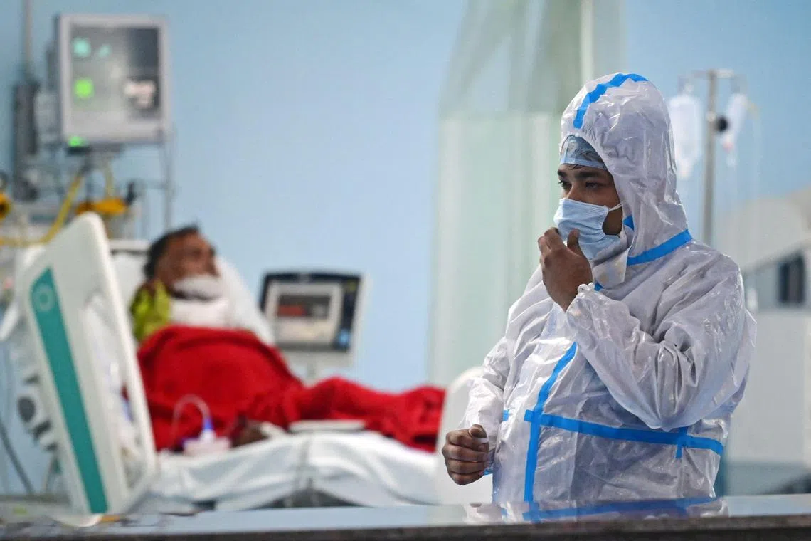 Health workers take part in a mock Covid-19 drill at a hospital in India.