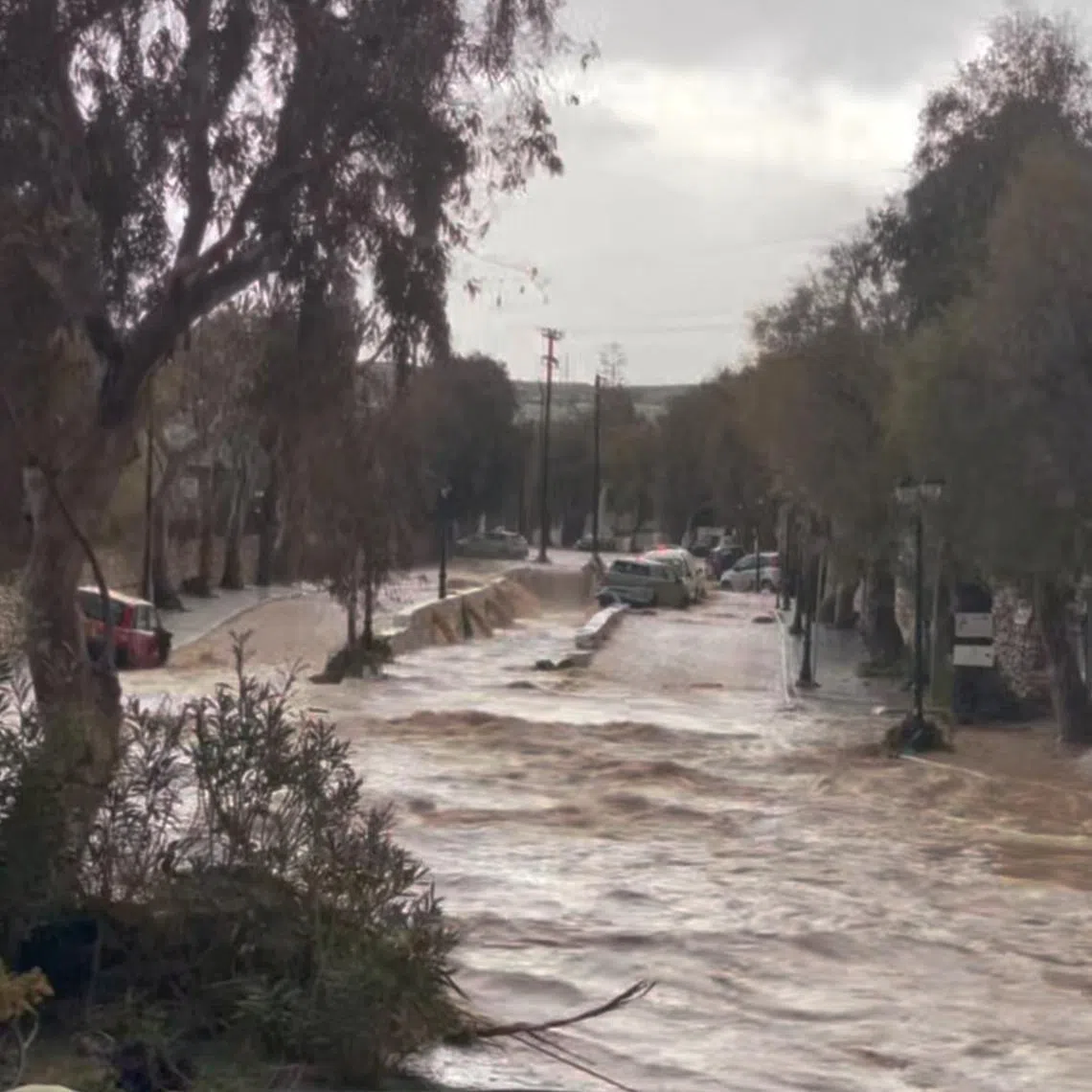 Stranded vehicles are seen in flood water in Naoussa, in the island of Paros, Greece March 31, 2025 in this screen grab from social media video. Lorene Junillon/via REUTERS  THIS IMAGE HAS BEEN SUPPLIED BY A THIRD PARTY. MANDATORY CREDIT. NO RESALES. NO ARCHIVES.