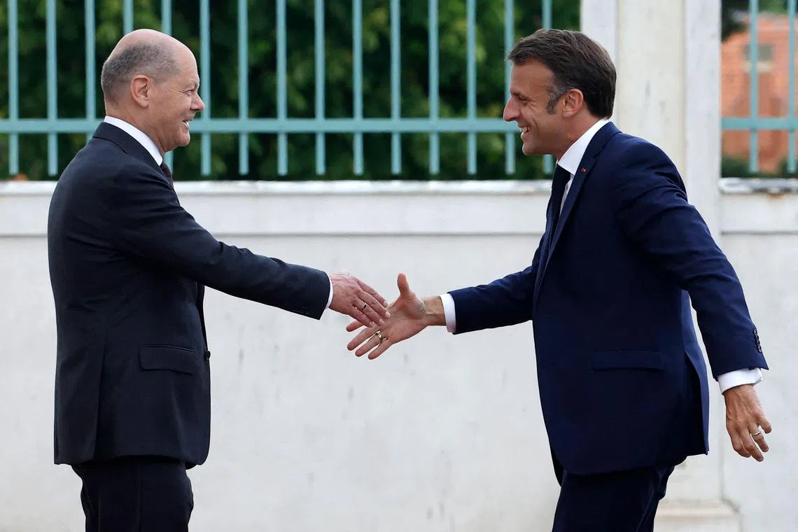 German Chancellor Olaf Scholz (left) welcoming French President Emmanuel Macron upon arrival for a joint Franco-German Cabinet meeting of ministers on May 28, 2024