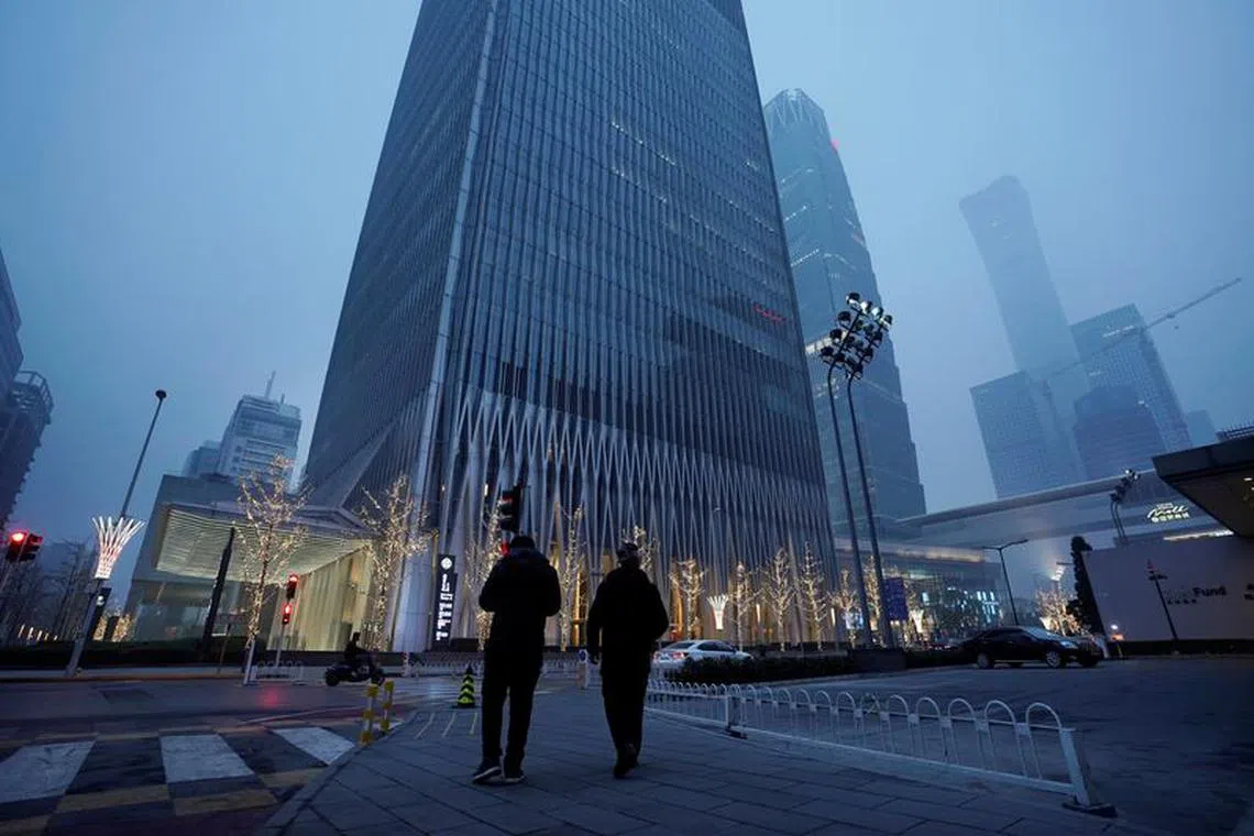 FILE PHOTO: Men walk amid heave smog on a polluted day in Beijing, China December 2, 2018. REUTERS/Jason Lee/File Photo