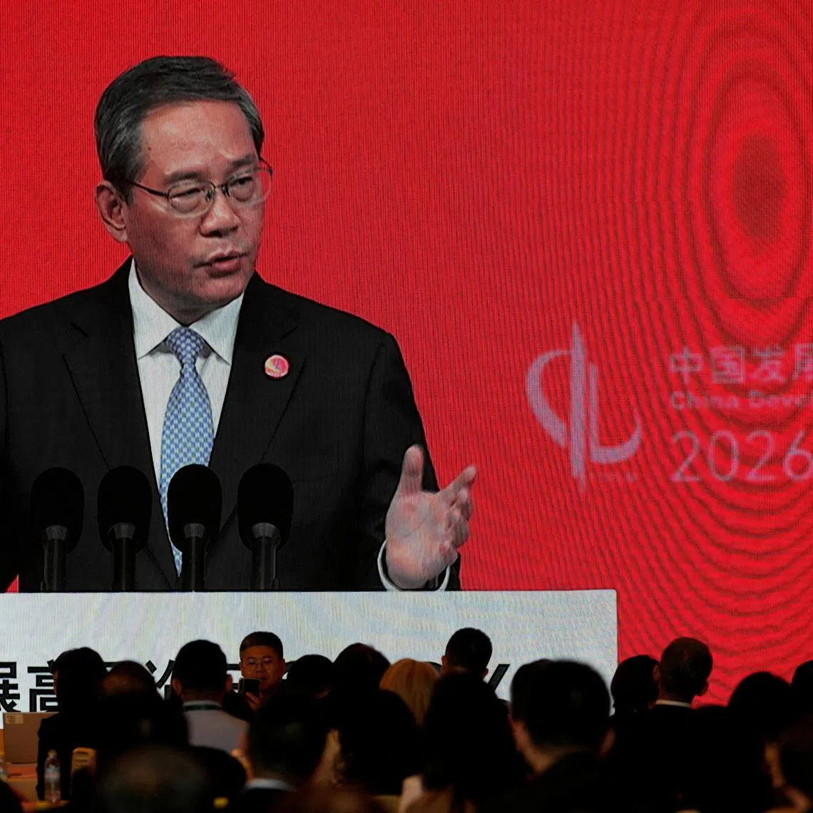 Chinese Premier Li Qiang on a big screen live broadcasting his speech at the opening of the China Development Forum 2026 held at the Diaoyutai State Guesthouse in Beijing, China, March 22, 2026.Ng Han Guan/Pool via REUTERS    Ng Han Guan/Pool via REUTERS