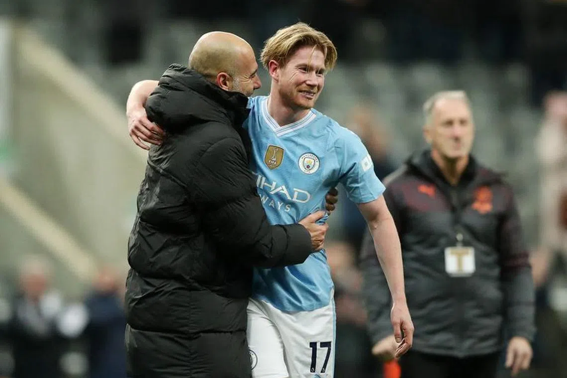 Soccer Football - Premier League - Newcastle United v Manchester City - St James' Park, Newcastle, Britain - January 13, 2024 Manchester City's Kevin De Bruyne celebrates with manager Pep Guardiola after the match REUTERS/Scott Heppell