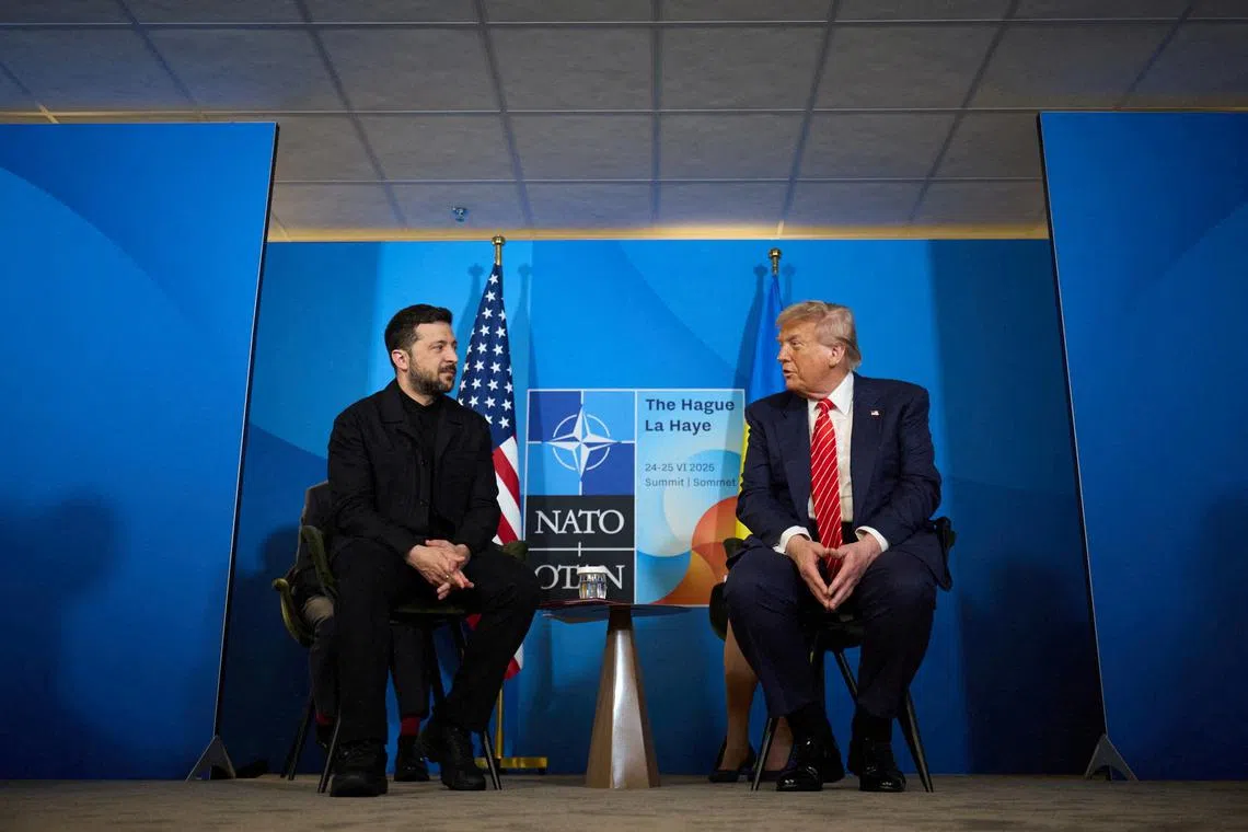 FILE PHOTO: U.S. President Donald Trump and Ukraine's President Volodymyr Zelenskiy attend a meeting at the NATO summit in The Hague, Netherlands June 25, 2025. Ukrainian Presidential Press Service/Handout via REUTERS