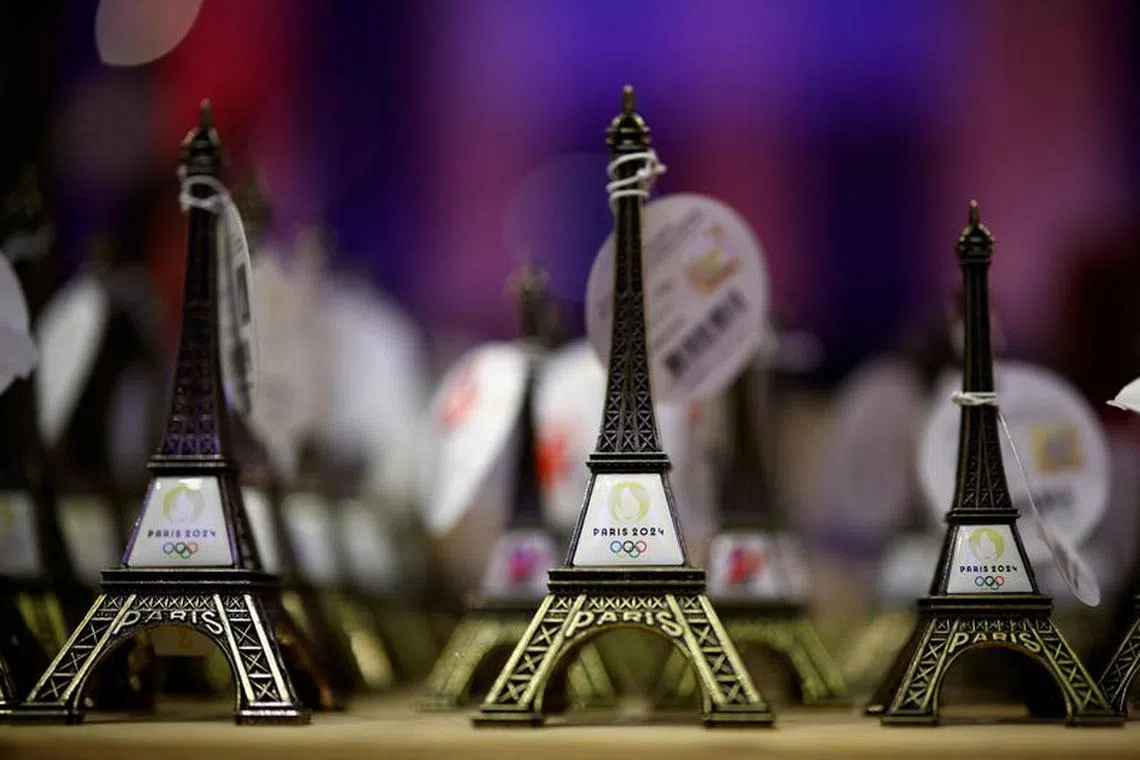 The logo of the Paris 2024 Olympic and Paralympic Games is seen on tiny Eiffel tower replicas inside an official Paris 2024 store at the Carrousel du Louvre in Paris, France, December 21, 2023. REUTERS/Sarah Meyssonnier