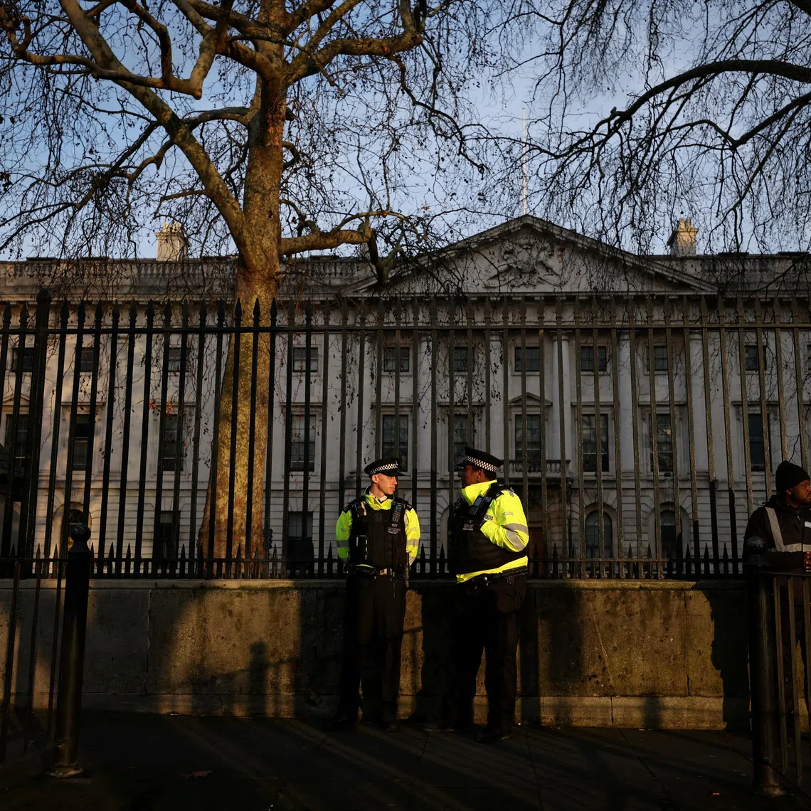 Police officers stand outside the Royal Mint Court, the proposed site of a new Chinese mega embassy at Royal Mint Court, in London.