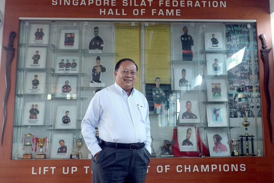 Mr Abdullah Shafiie Mohd Sidik, President of Singapore Silat Federation (PERSISI), posing with PERSISI's hall of fame in the background.
