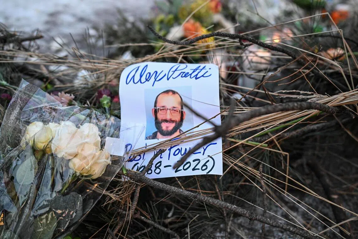 A photo of ICU nurse Alex Pretti is seen at a makeshift memorial at the site in Minneapolis where he was shot and killed by federal immigration agents on Jan 24.