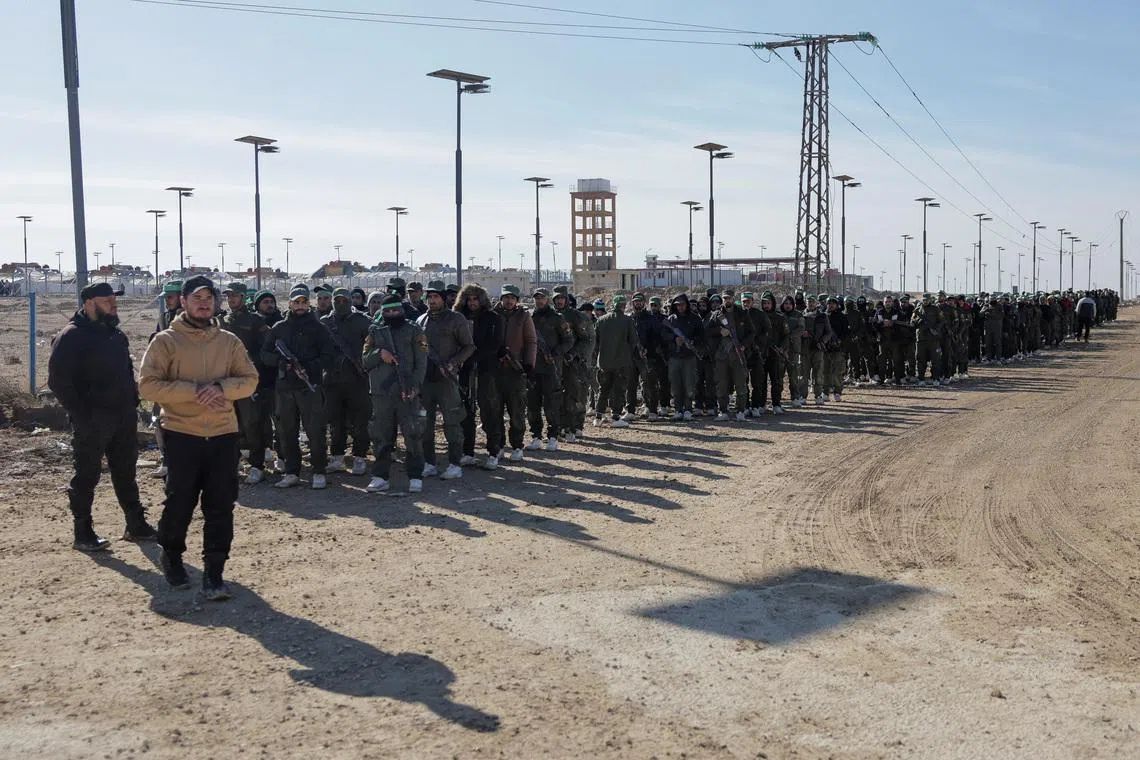 Members of the Syrian government security forces gather after they took control of al-Hol camp following the withdrawal of Syrian Democratic Forces (SDF), in Hasaka, Syria, January 21, 2026. REUTERS/Khalil Ashawi