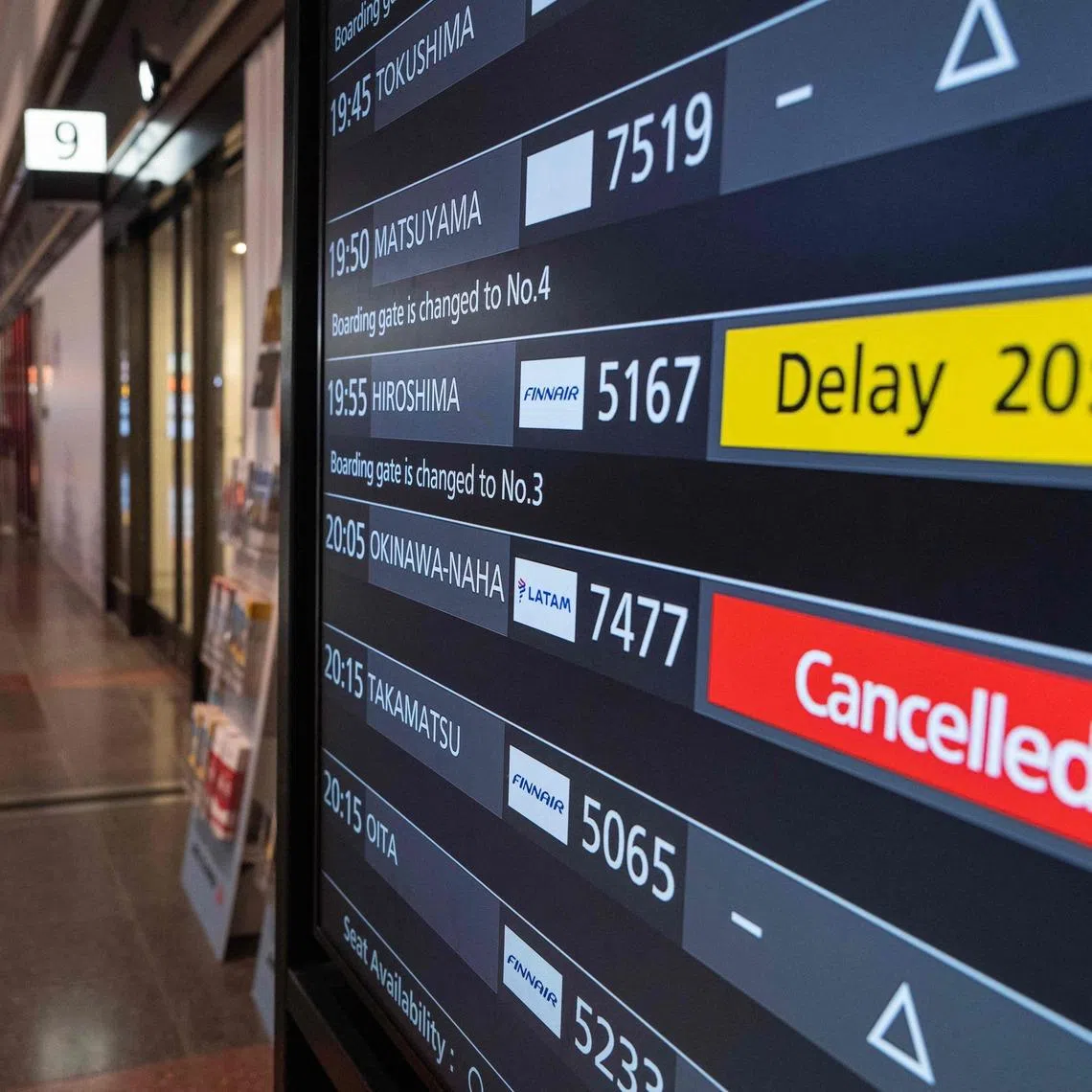 A departures board shows delayed and cancelled flights after severe tropical storm Jangmi shut down the Okinawan airport on June 1.