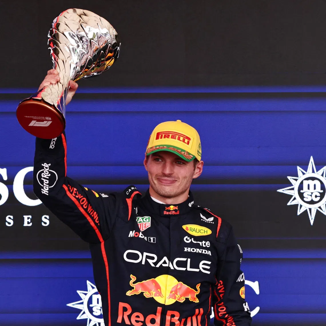 Formula One F1 - Sao Paulo Grand Prix - Autodromo Jose Carlos Pace, Sao Paulo, Brazil - November 9, 2025 Red Bull's Max Verstappen celebrates on the podium with a trophy after finishing third in the Sao Paulo Grand Prix REUTERS/Jean Carniel