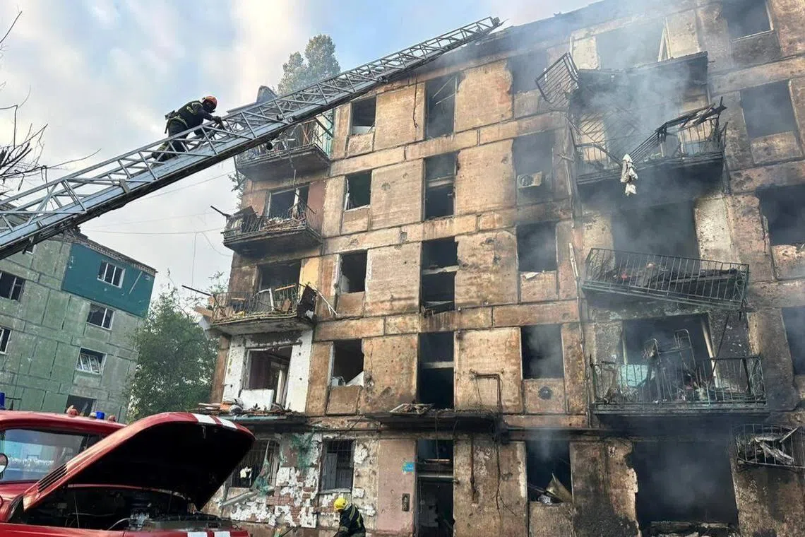 Rescuers work at a five-storey apartment building in Kryvyi Rih city that was hit in a new wave of Russian missile strikes.