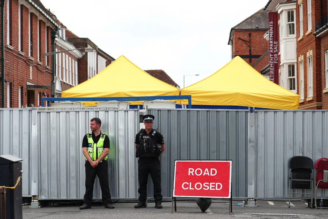 Police officers stand outside the street where Dawn Sturgess lived before dying after being exposed to a Novichok nerve agent, in Salisbury, Britain, July 19, 2018. REUTERS/Hannah McKay