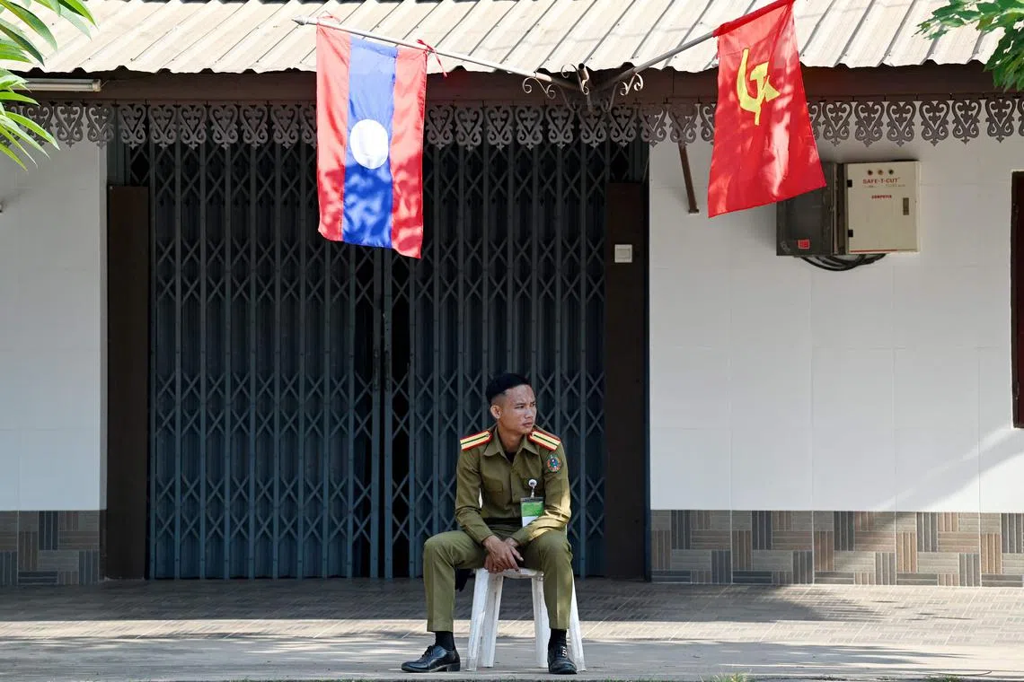 A police official keeps watch during the Association of Southeast Asian Nations (ASEAN) Summit in Vientiane on Oct 8.