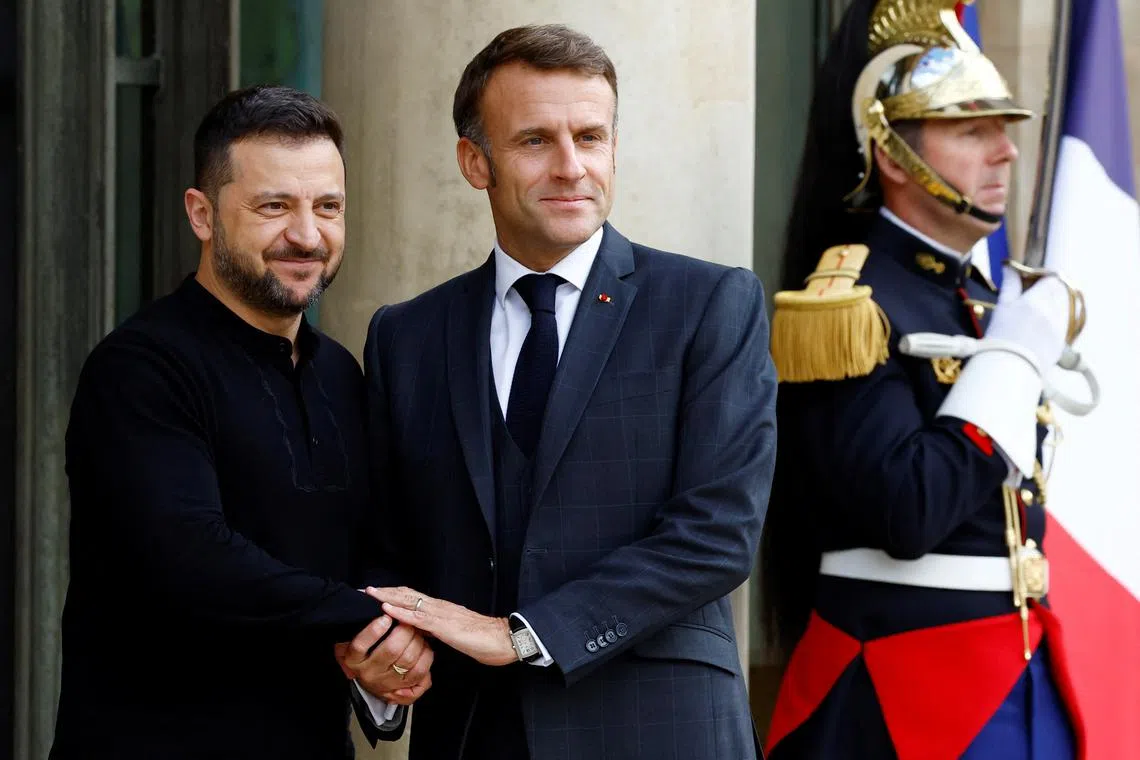 FILE PHOTO: French President Emmanuel Macron shakes hands with Ukraine's President Volodymyr Zelenskiy as he arrives for a meeting at the Elysee Palace in Paris, France, October 10, 2024. REUTERS/Stephanie Lecocq/File Photo