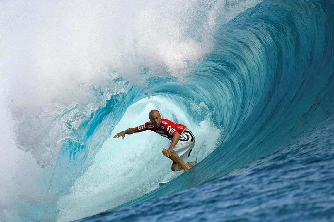 FILE PHOTO: Surfer Kelly Slater of the U.S rides a wave during the third round of competition in the Billabong Pro surfing tournament on the legendary reef break in Teahupoo, Tahiti, May 14, 2008. REUTERS/Joseba Etxaburu/File Photo