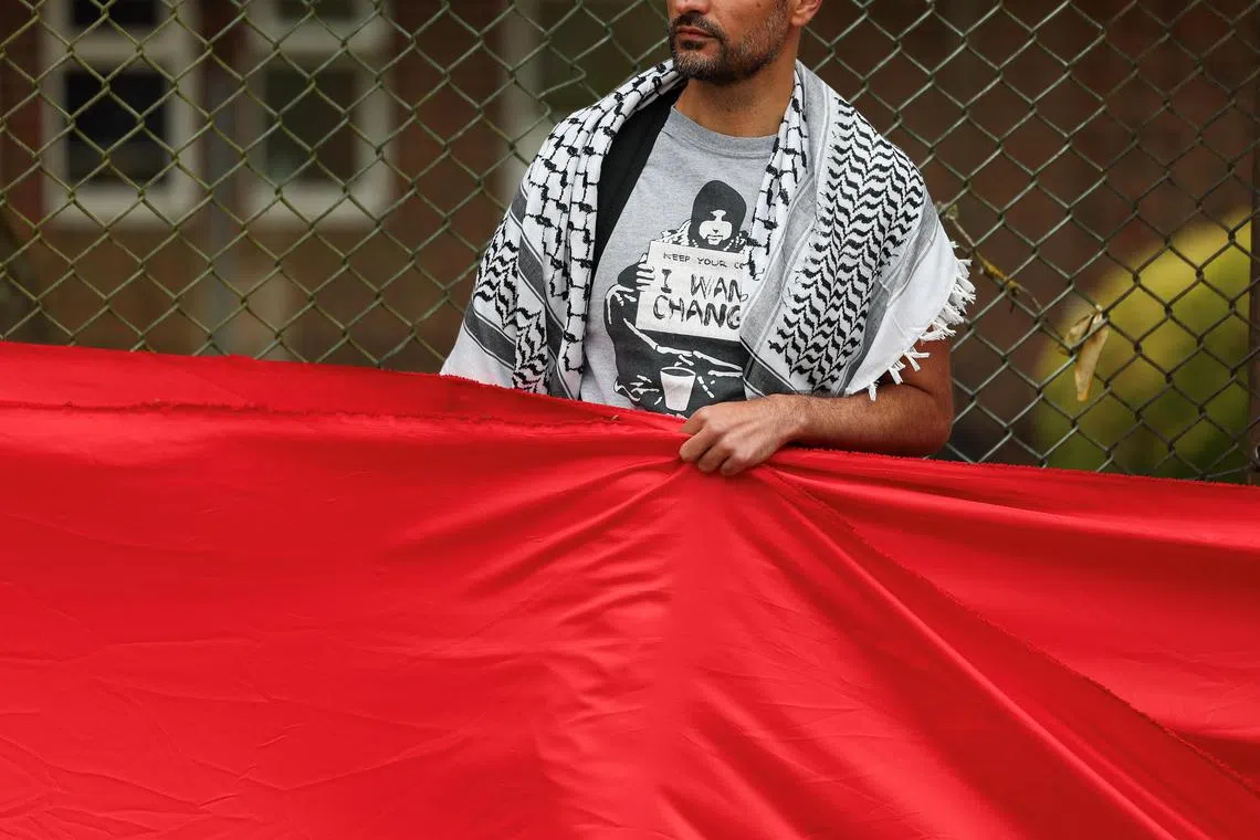 A pro-Palestinian demonstrator in the UK wearing a keffiyeh scarf.