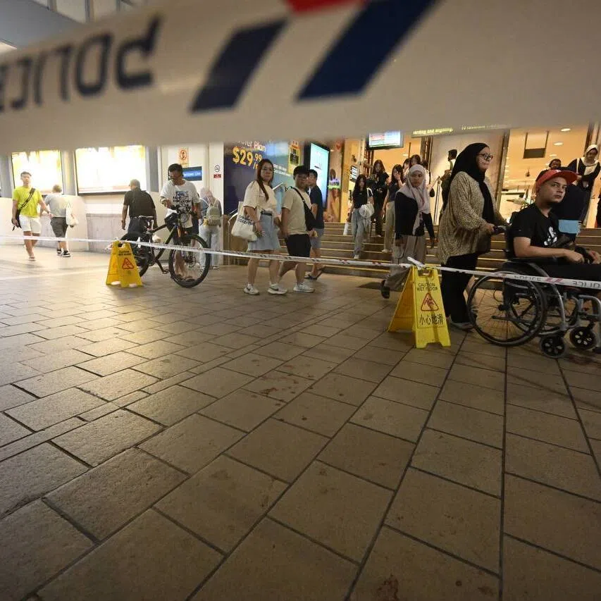 Police cordon in an area with bloodstain on the floor at the pedestrian crossing between Tampines MRT and Tampines Mall on Dec 19.