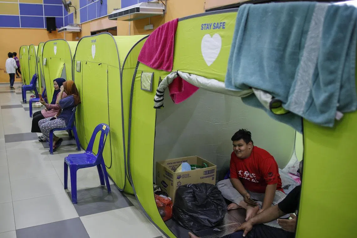 A man is seen inside a tent at an evacuation centre in Kota Tinggi, Johor.