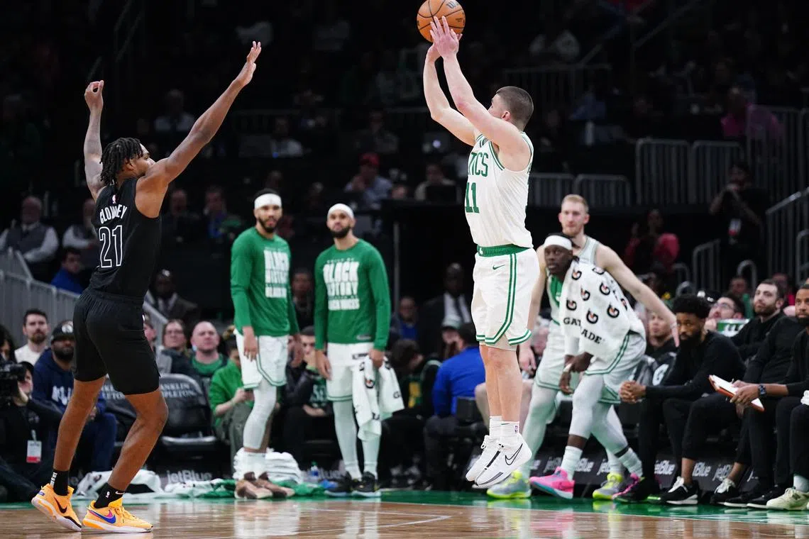 Boston Celtics guard Payton Pritchard shooting a three-pointer against Brooklyn Nets forward Noah Clowney in the second half at TD Garden on Feb 14. He scored 28 points off the bench in the Celtics' 136-86 win.