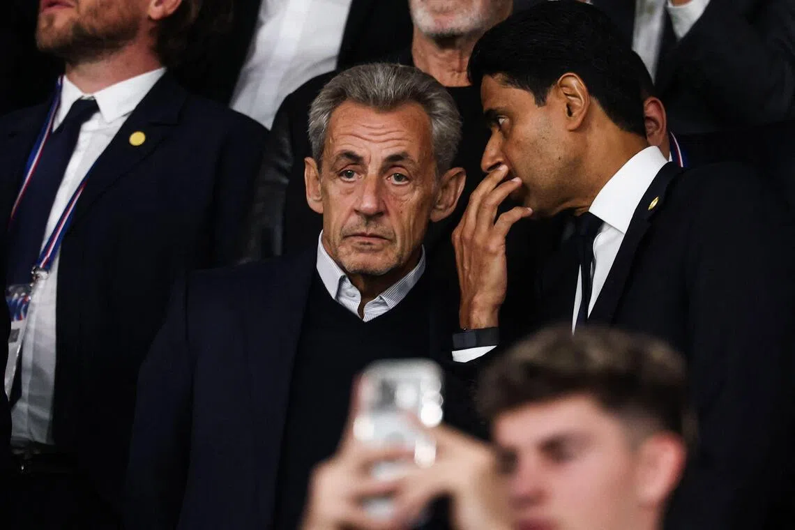 France’s former president Nicolas Sarkozy (left) and Paris Saint-Germain’s Qatari president Nasser al-Khelaifi speaking during the Champions League clash against Slovan Bratislava at the Parc des Princes in Paris on Sept 9.