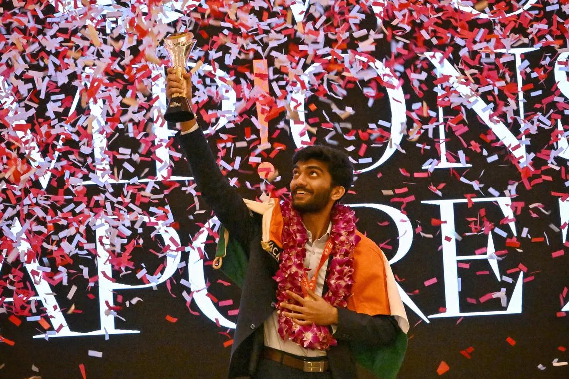 World chess champion Gukesh Dommaraju lifting his trophy after defeating Ding Liren to win the title.